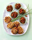 Meatballs muffins and veggie burgers in paper cups on plate
