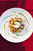 Porcini salad with shells, flowers and poached egg on plate