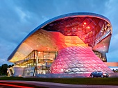 Colourful glass facade of BMW World at evening in Munich, Germany