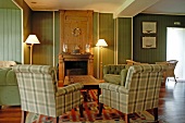 Fireplace lounge with plaid sofa set at Grand Hotel des Bains, in Locquirec, France