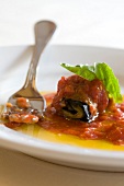 Stuffed eggplant rolls with provolone cheese and tomato sugo on plate