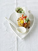 A baked potato with vegetable quark, chives and pepper