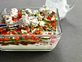 Goat cheese, potato, zucchini gratin, tomato, sage and cream in serving tray