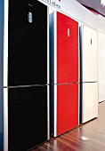 Black, red and white refrigerators in row