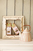 Two packets of teas in picture frame with tea pot