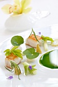 Close-up of smoked turbot with herb leaves on plate