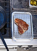 Steak kept for resting on stainless steel grill