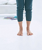 Close-up of woman's leg with barefoot wearing leggings, low section