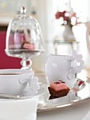 Cup of tea with chocolate on silver tray
