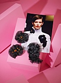 Various black brooches with photo on pink background