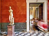 Visitors looking at statues in Hermitage Museum, St. Petersburg, Russia