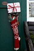 Christmas stocking and gift hanging on door