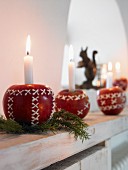 Candles in Christmas apples on a window sill
