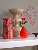 Two red and beige colour vases with flower in jug