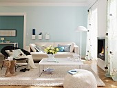 Living room with white furniture and pale blue and turquoise walls
