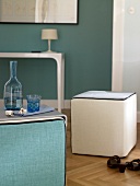 White upholstered cube on wooden surface