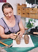 Shoemaker Anja Hoffmann preparing shoe