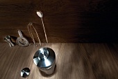 Various kitchen utensils measuring cup, strainer, ice tongs, spoon and shaker