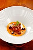 Beef tartare with pepper sauce, porcini mushroom, jelly and black olives on plate