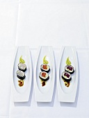 Sushi with prawns, salmon and tuna in serving dishes