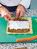 Putting coriander leaves on tuna with wasabi