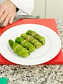 Dish with stuffed cabbage rolls on red board