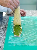 Preparing roulade with artic char on cutting board