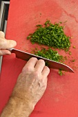 Chervil being chopped on board