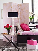 Tray table, pink folding partition and bench with cushions in living room
