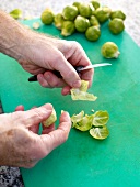 Brussels sprouts being cleaned on cutting board