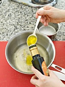 Adding olive oil in pan