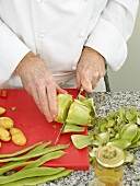 Artichoke being cut with knife