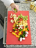 Lime being squeezed on chopped vegetables