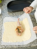 Stuffed lamb's leg being wrapped in salt dough