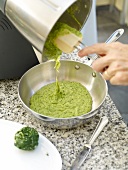 Removing turnip green mixture from mixer in pan
