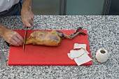 Cutting head of pheasant on cutting board