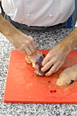 Removing skin of duck on cutting board