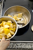 Putting quince pieces in pan