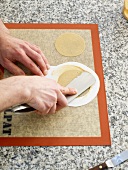 Circle being made from dough for plate decoration