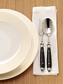 Close-up of table setting with plates and silverware