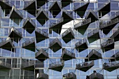 Glass facade of VM-house with triangular balconies in Copenhagen, Denmark