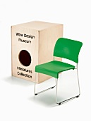 Green chair and wooden box against white background