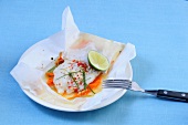 Asian fish with lemon on white paper