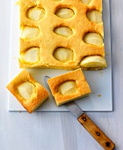 Pieces of apple pie with knife on chopping board