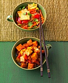 Stir fried vegetables with tempeh and tempeh curry with pumpkin in bowls