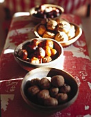Several bowls with nuts and chestnuts