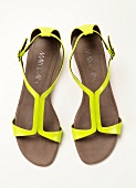 Strap sandals in neon colour on white background