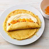 Rolling pancakes with curd and apricot for preparation of pancake apricot curd, step 2