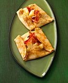 Two galettes with pears and bacon on plate