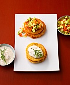 Blini with salmon tartare and pancakes with fish cream on plate